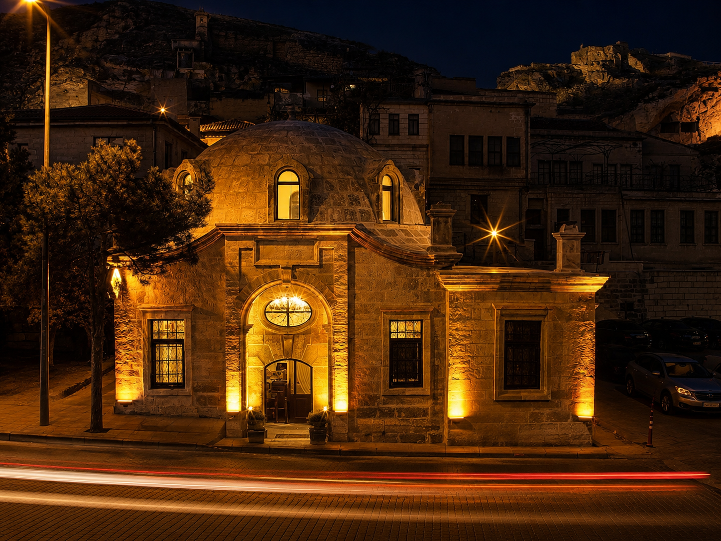 Front view of Ürgüp Hamam illuminated at night beneath the Cappadocia rock formations